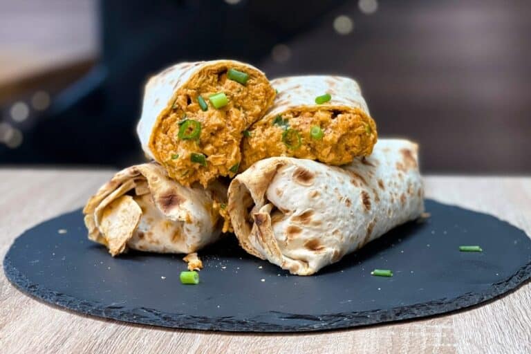 Tasty high-protein chicken burrito served on a stone plate