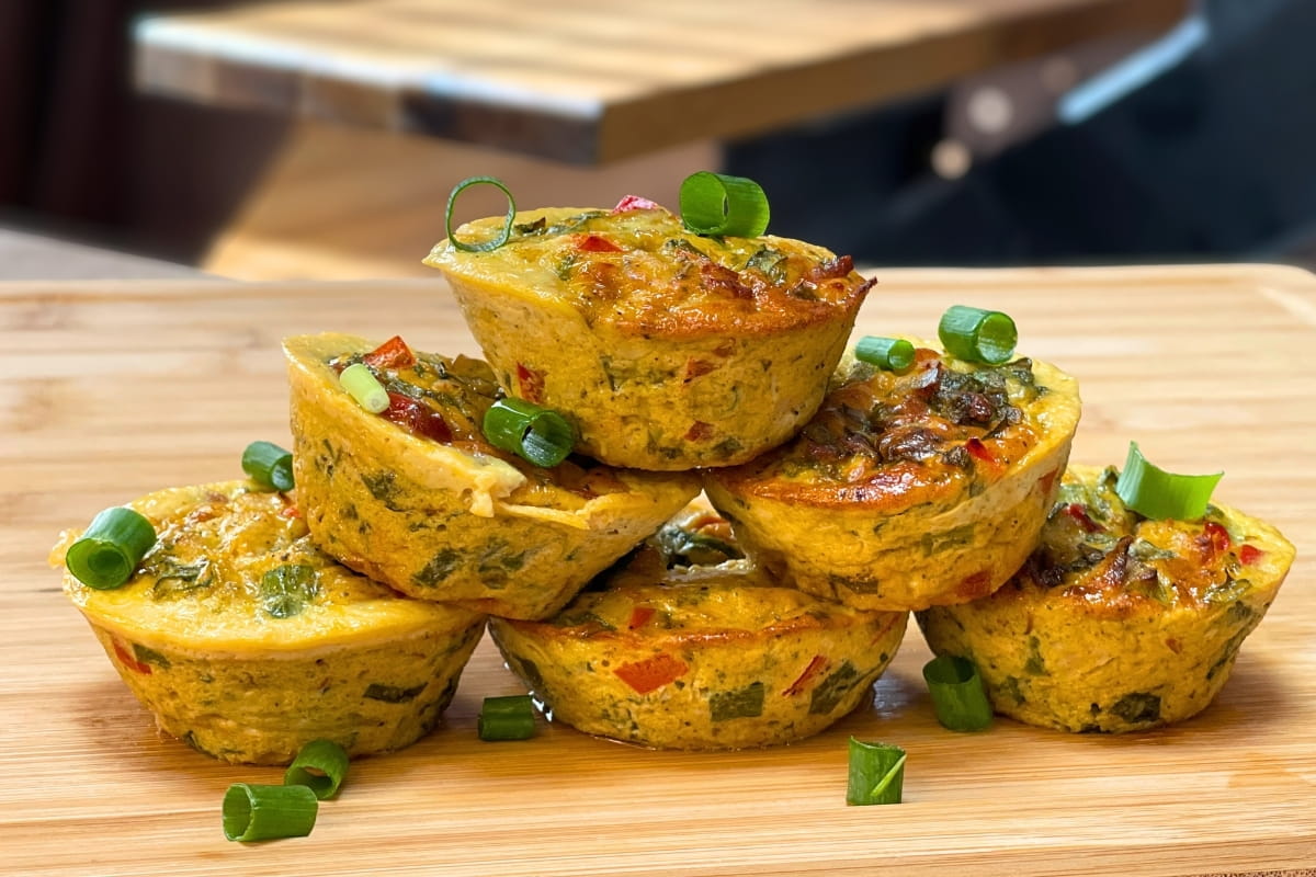Savory High-Protein Breakfast Muffins sprinkled with pieces of spring onion