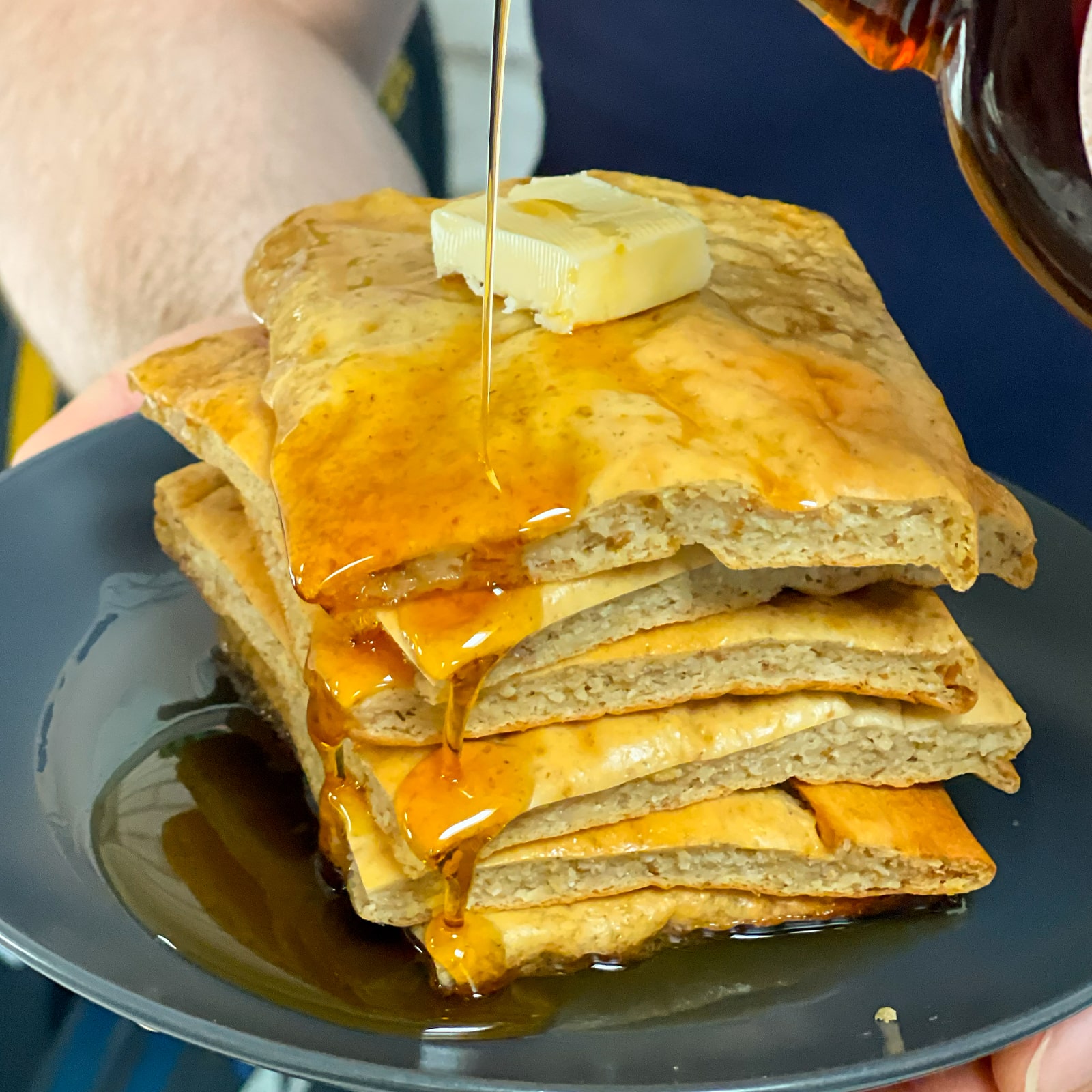 Meal Prep Sheet Pan Protein Pancakes with butter and maple syrup poured over it
