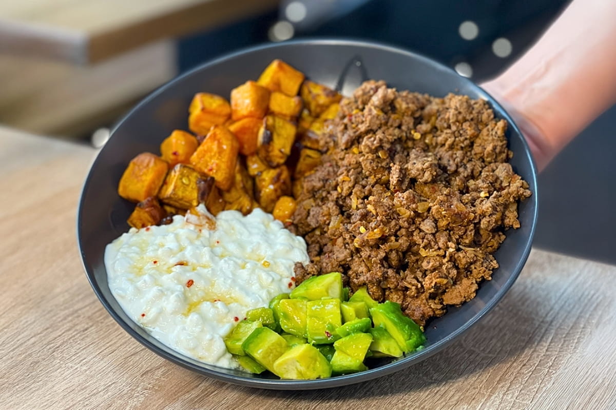 High-Protein Hot Honey Cottage Cheese Beef Bowl with avocado and crispy sweet potato cubes