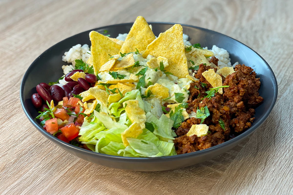 High-Protein Beef Burrito Bowl with rice, guacamole, pico de gallo, lettuce and crispy tortilla chips
