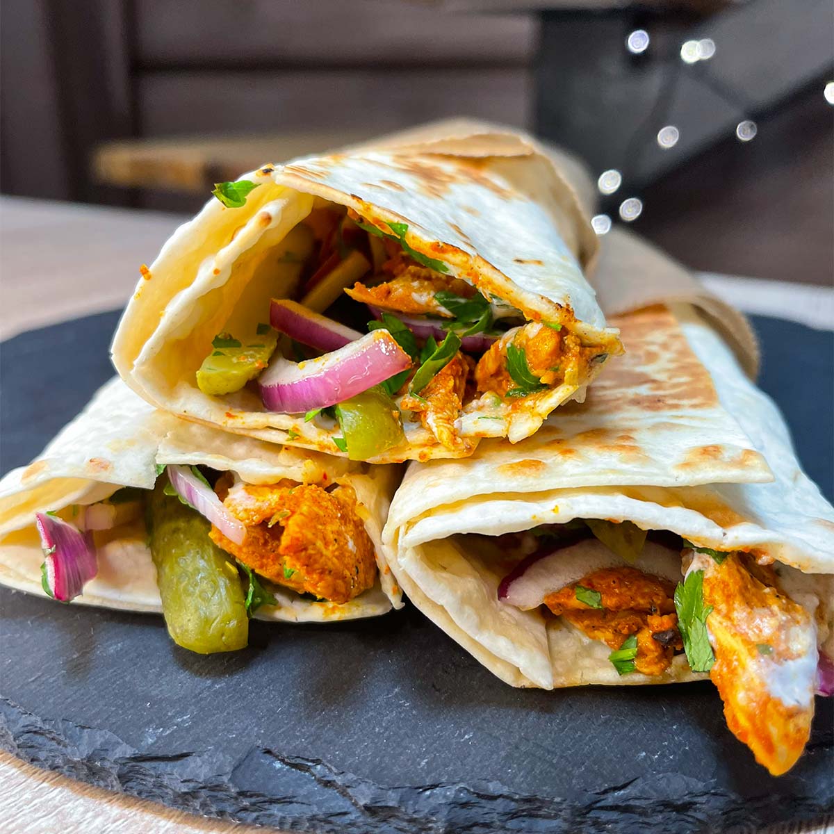 Close-up photo of High-Protein Chicken Shawarma wrapped in baking paper, and served on a stone plate