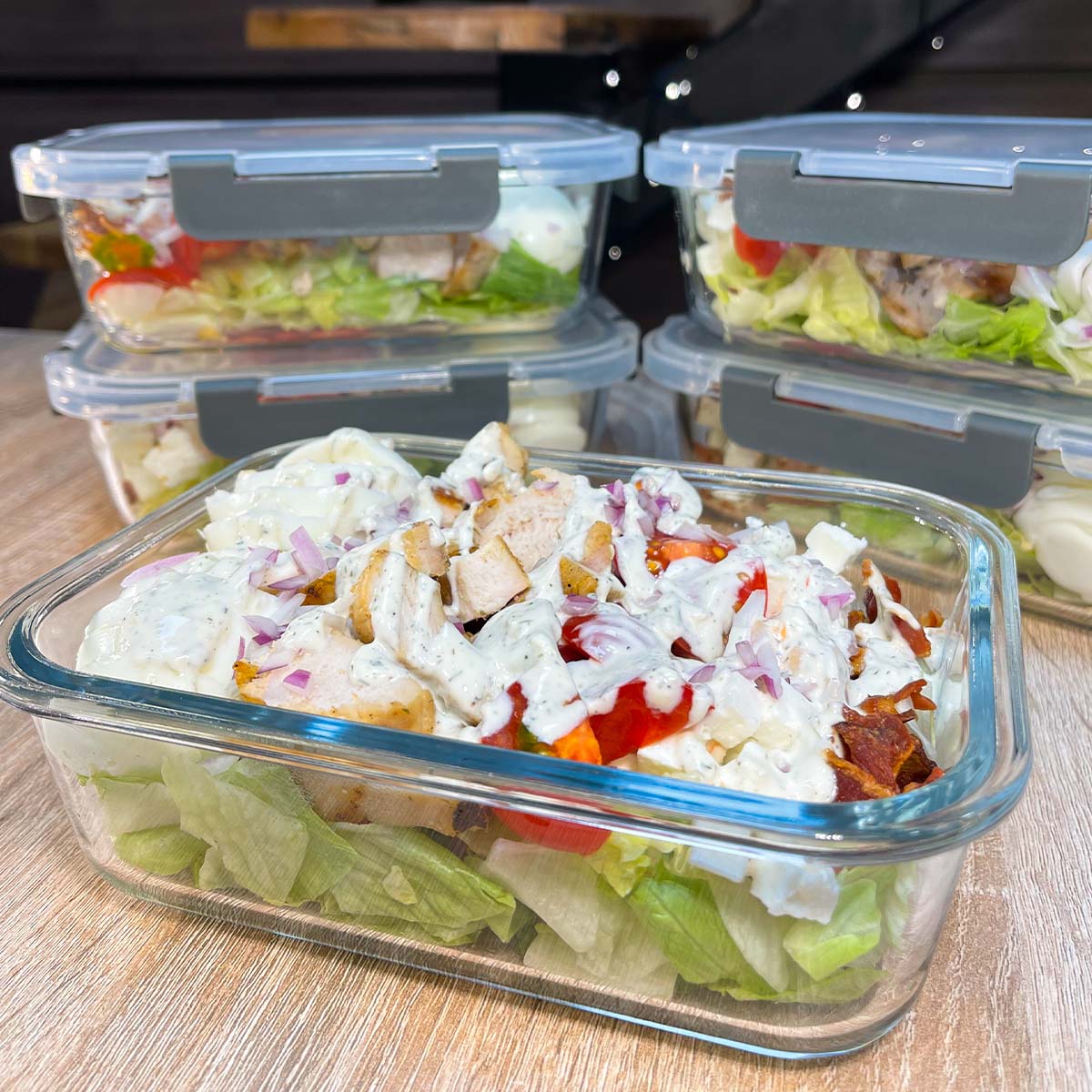 Close-up photo of High-Protein Cobb Salad served in meal prep containers